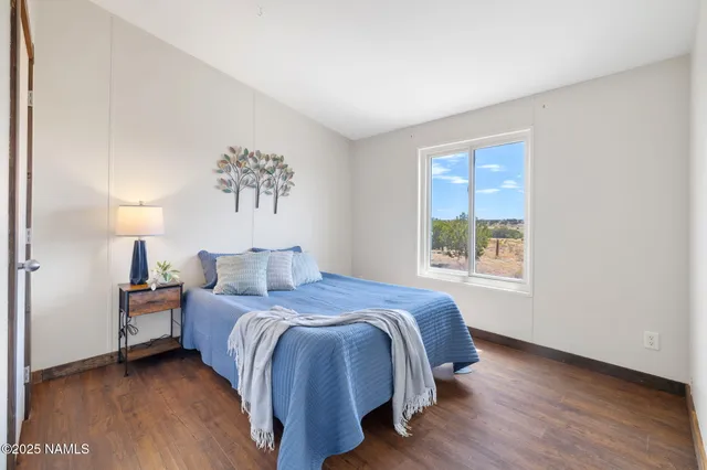 a spacious bedroom with a bed and a window