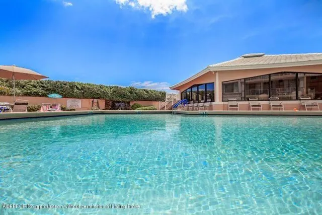 a front view of a house with a yard table and chairs