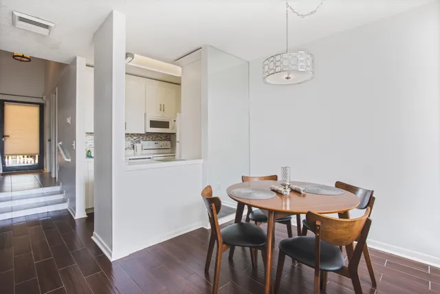 a view of a dining room with furniture and wooden floor