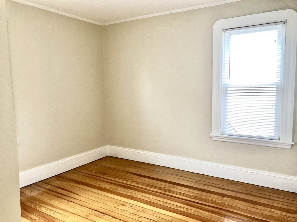 30 Rodney Street, Unit 2 New Bedford, MA 02744 - Photo 11 of 15 a view of a small space with wooden floor and a window