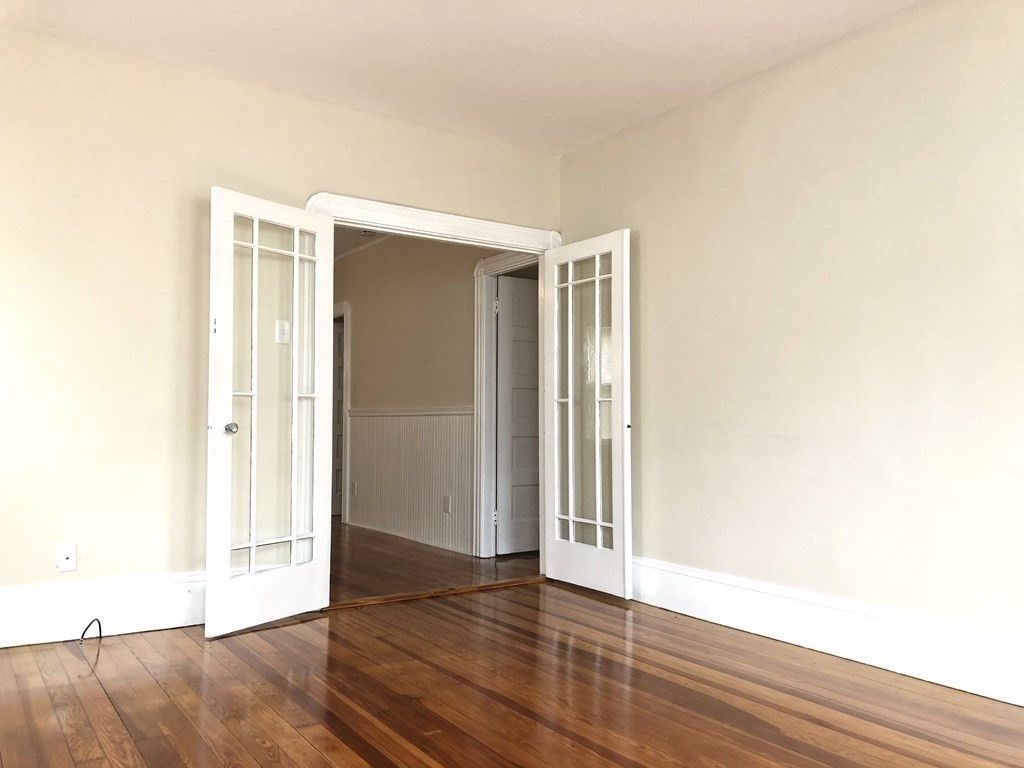 30 Rodney Street, Unit 2 New Bedford, MA 02744 - Photo 3 of 15 a view of an empty room with wooden floor