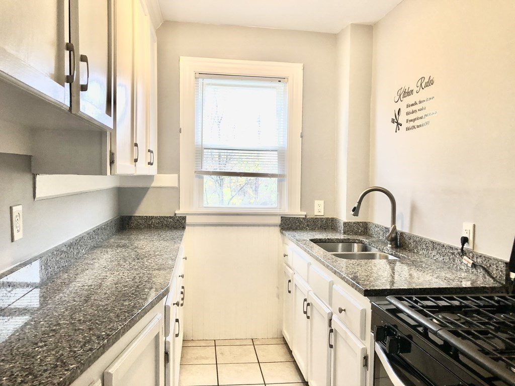 30 Rodney Street, Unit 2 New Bedford, MA 02744 - Photo 8 of 15 a kitchen with a sink and a stove top oven