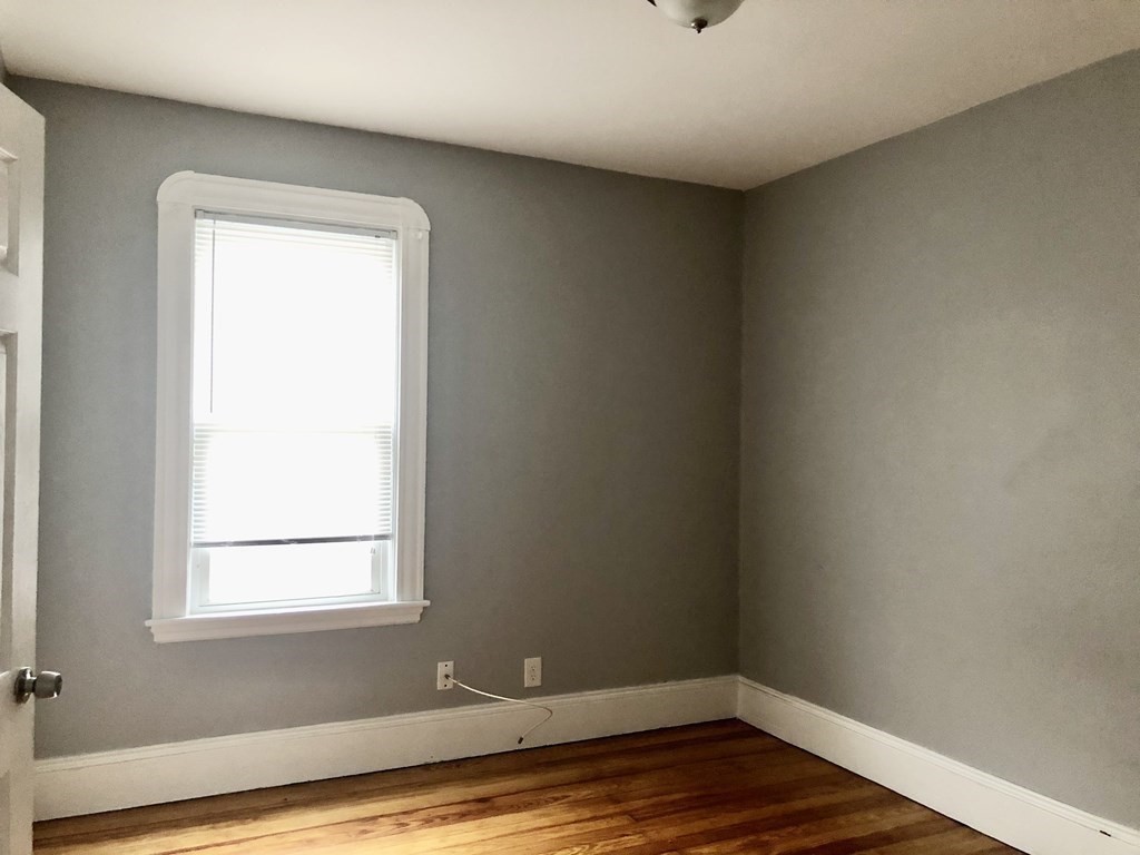 30 Rodney Street, Unit 2 New Bedford, MA 02744 - Photo 9 of 15 a view of a small space with wooden floor and a window