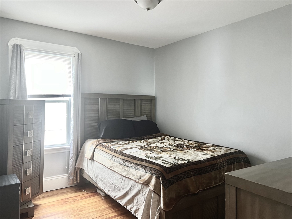 30 Rodney Street, Unit 2 New Bedford, MA 02744 - Photo 10 of 15 a bedroom with a bed and a window