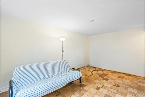 a bedroom with furniture and a rug