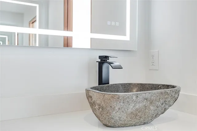 a bedroom with a bed and a large mirror