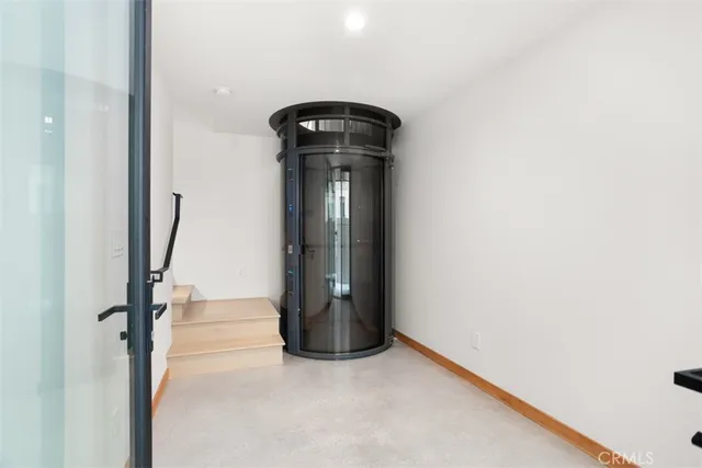 a large white kitchen with kitchen island a sink stainless steel appliances and cabinets