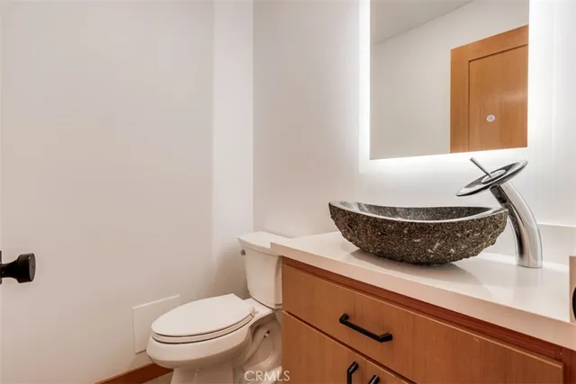 a kitchen with granite countertop a sink stove and cabinets