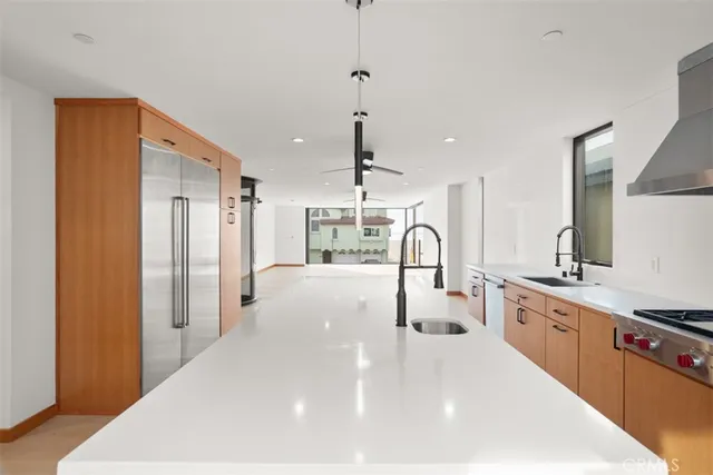 a kitchen with a refrigerator and a sink