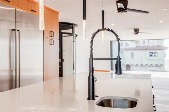 a large kitchen with stainless steel appliances a refrigerator and a sink