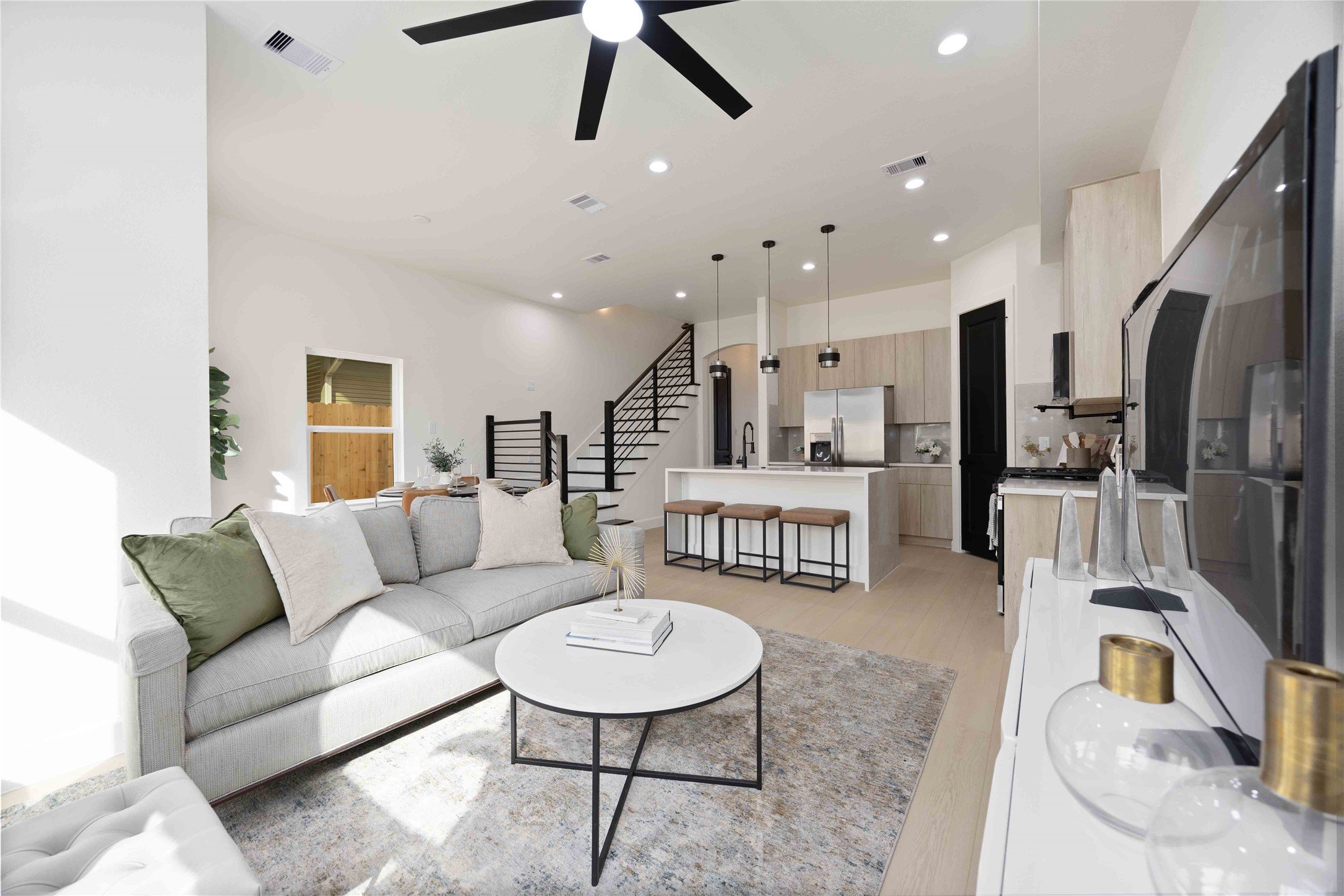 3528 Amos Street Houston, TX 77021 - Photo 13 of 30 a living room with furniture kitchen view and a wooden floor