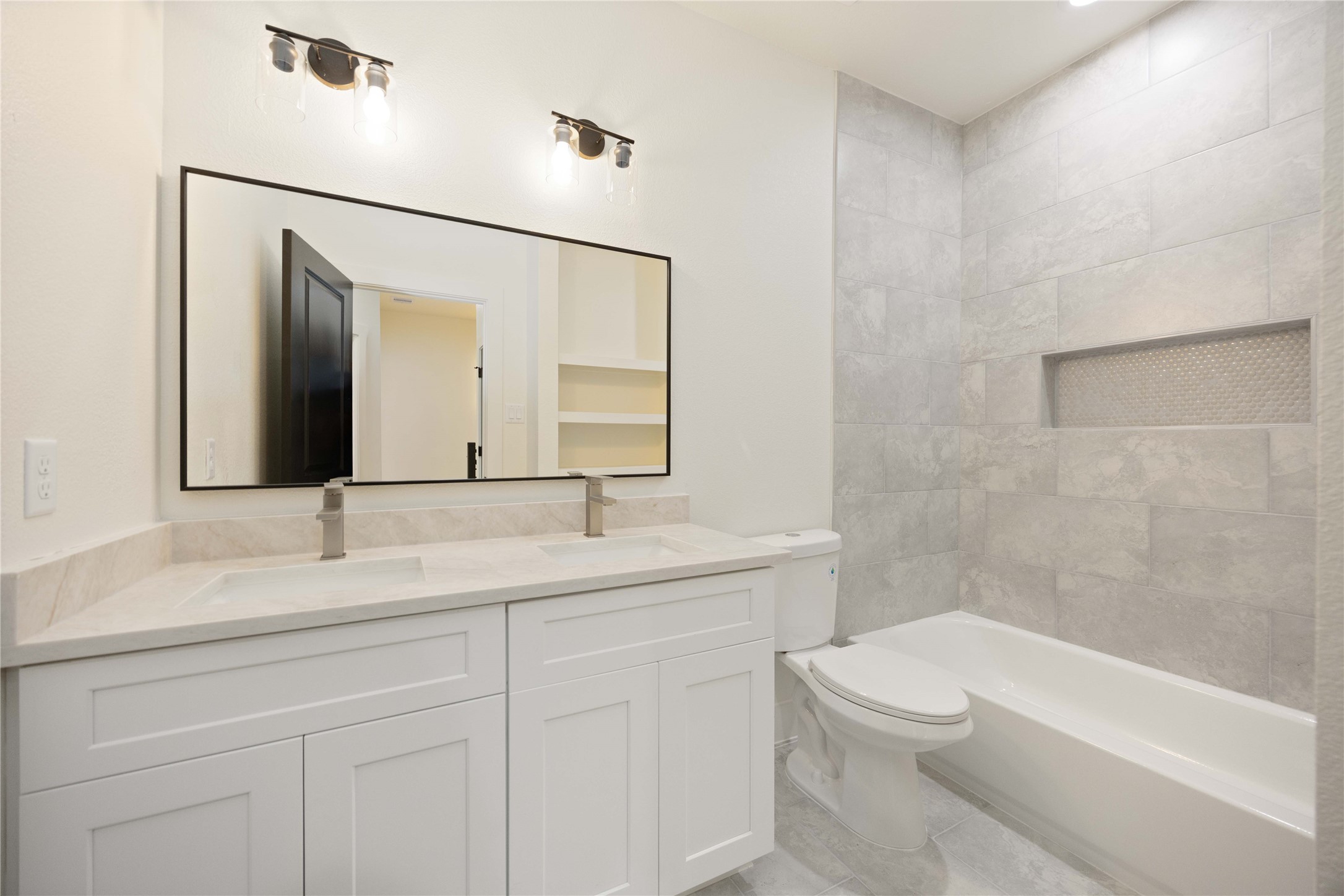 3528 Amos Street Houston, TX 77021 - Photo 17 of 30 a bathroom with a toilet a sink a bathtub and a mirror