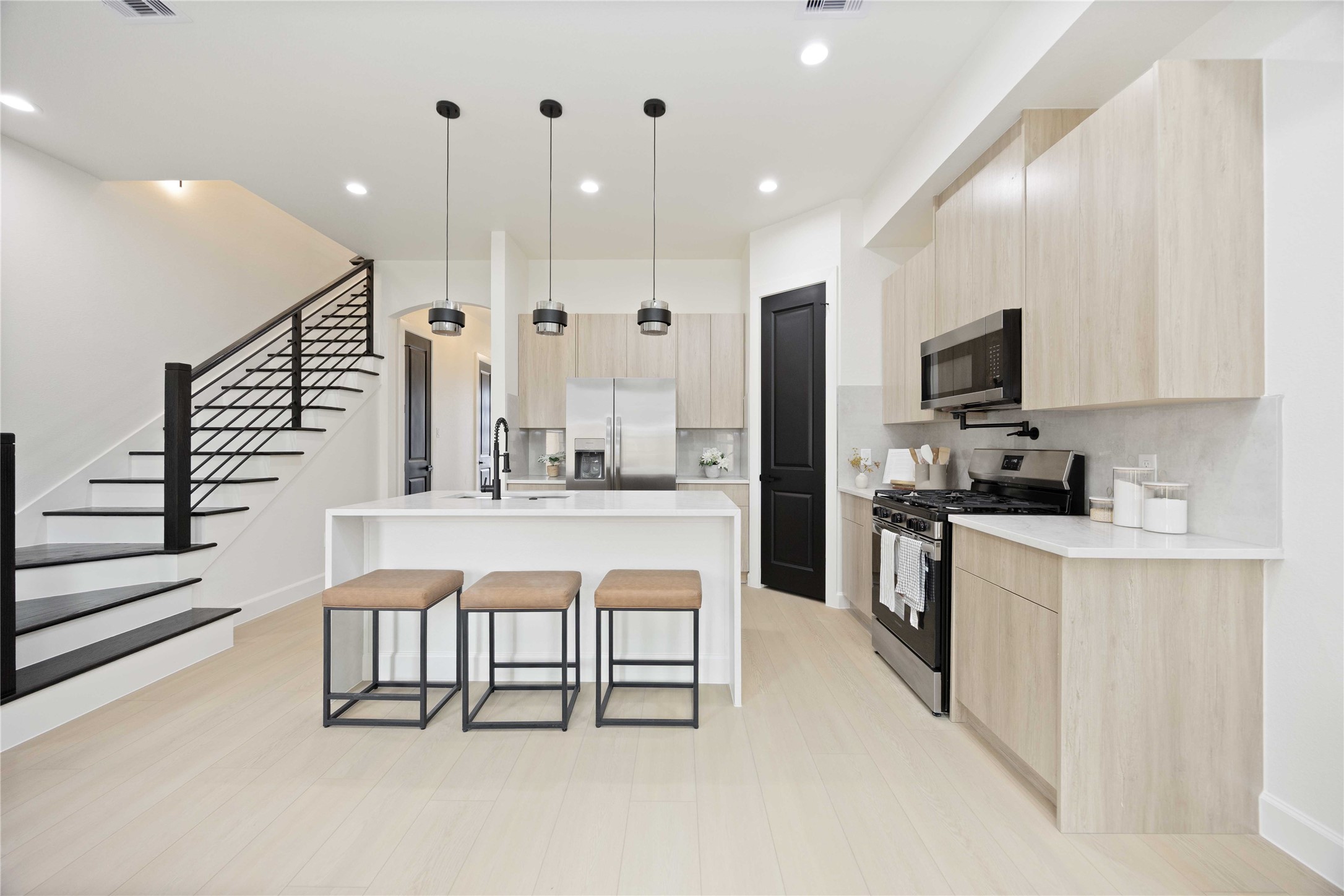 3528 Amos Street Houston, TX 77021 - Photo 8 of 30 a large white kitchen with kitchen island granite countertop a stove a sink a refrigerator and white cabinets with wooden floor