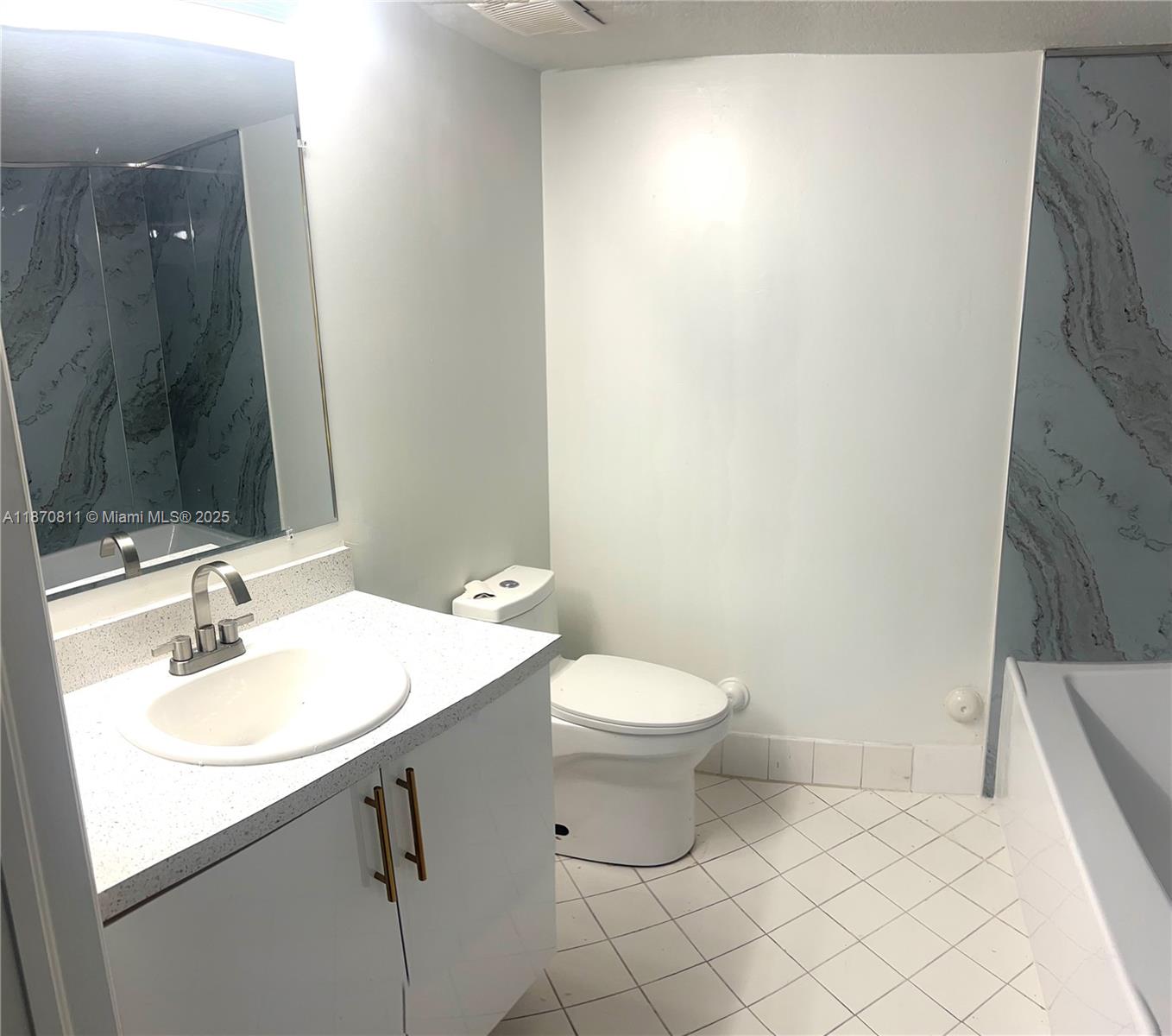 1240 Southeast 28th Court, Unit 101 Homestead, FL 33035 - Photo 11 of 20 a bathroom with a sink and a mirror