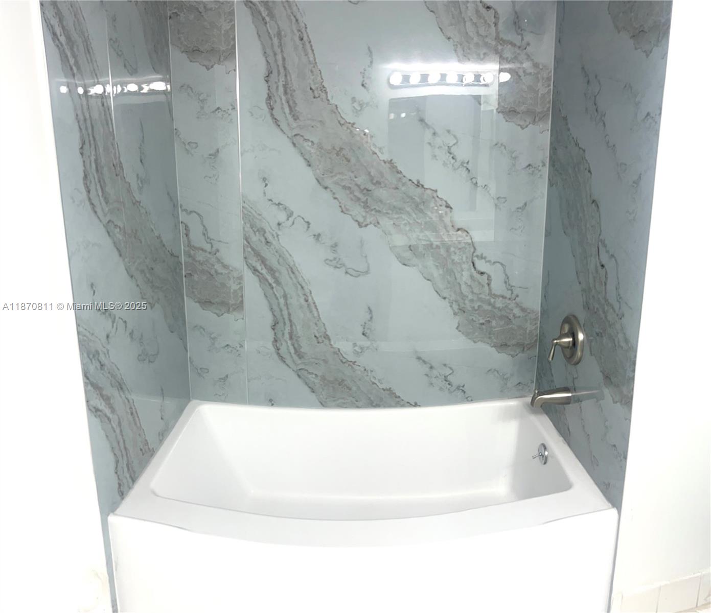 1240 Southeast 28th Court, Unit 101 Homestead, FL 33035 - Photo 12 of 20 a bathroom with a bathtub