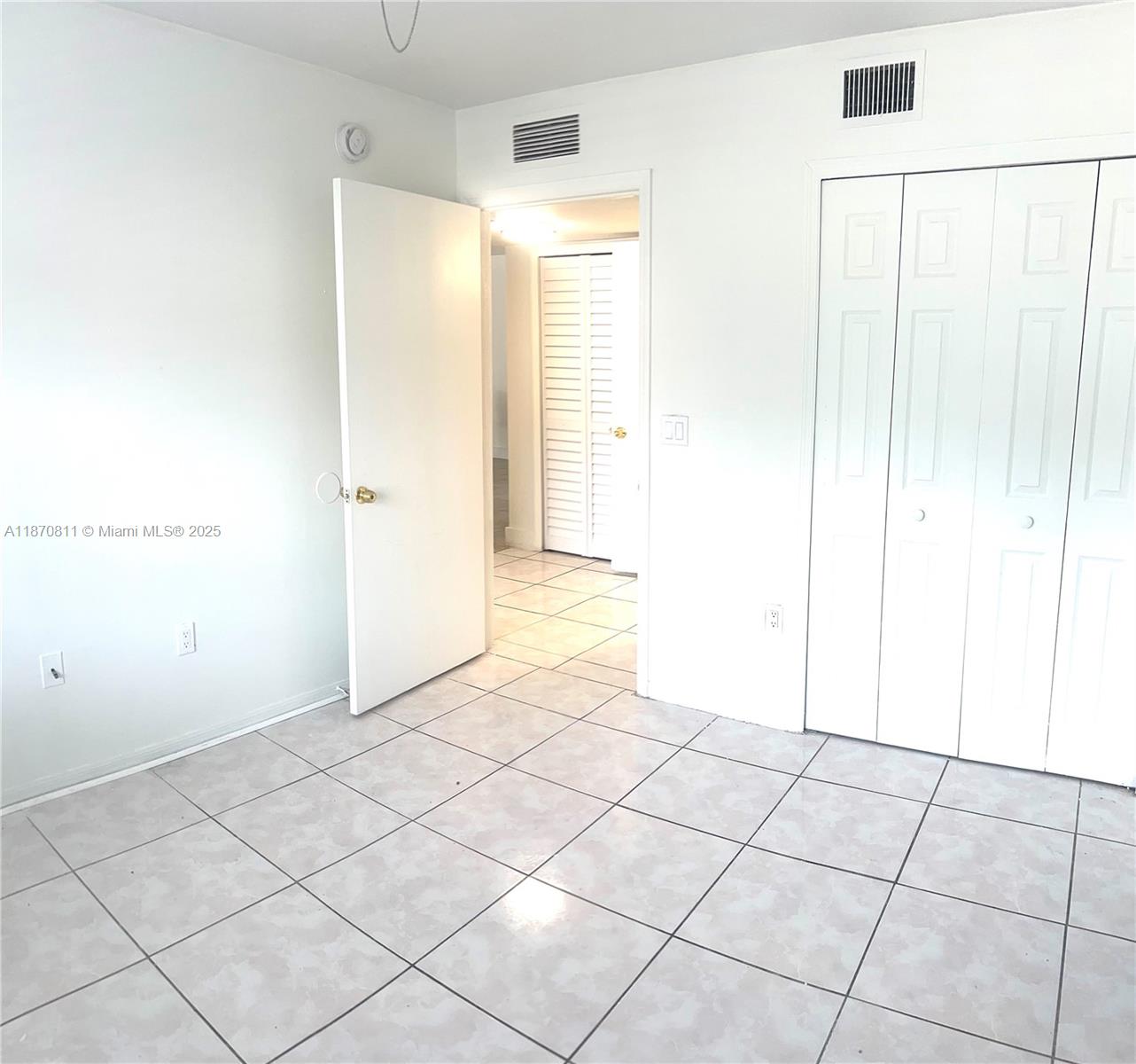 1240 Southeast 28th Court, Unit 101 Homestead, FL 33035 - Photo 14 of 20 a view of an empty room and window