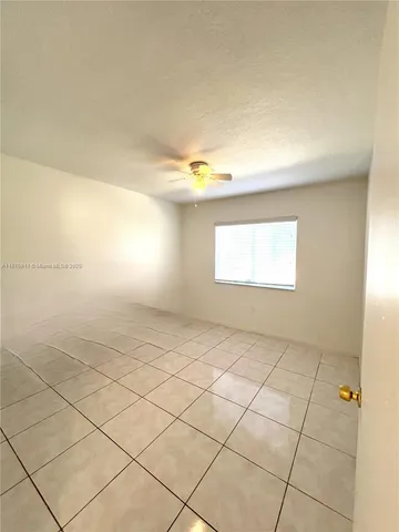 a view of an empty room and a window