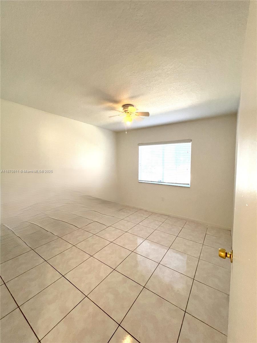 1240 Southeast 28th Court, Unit 101 Homestead, FL 33035 - Photo 15 of 20 a view of an empty room and a window