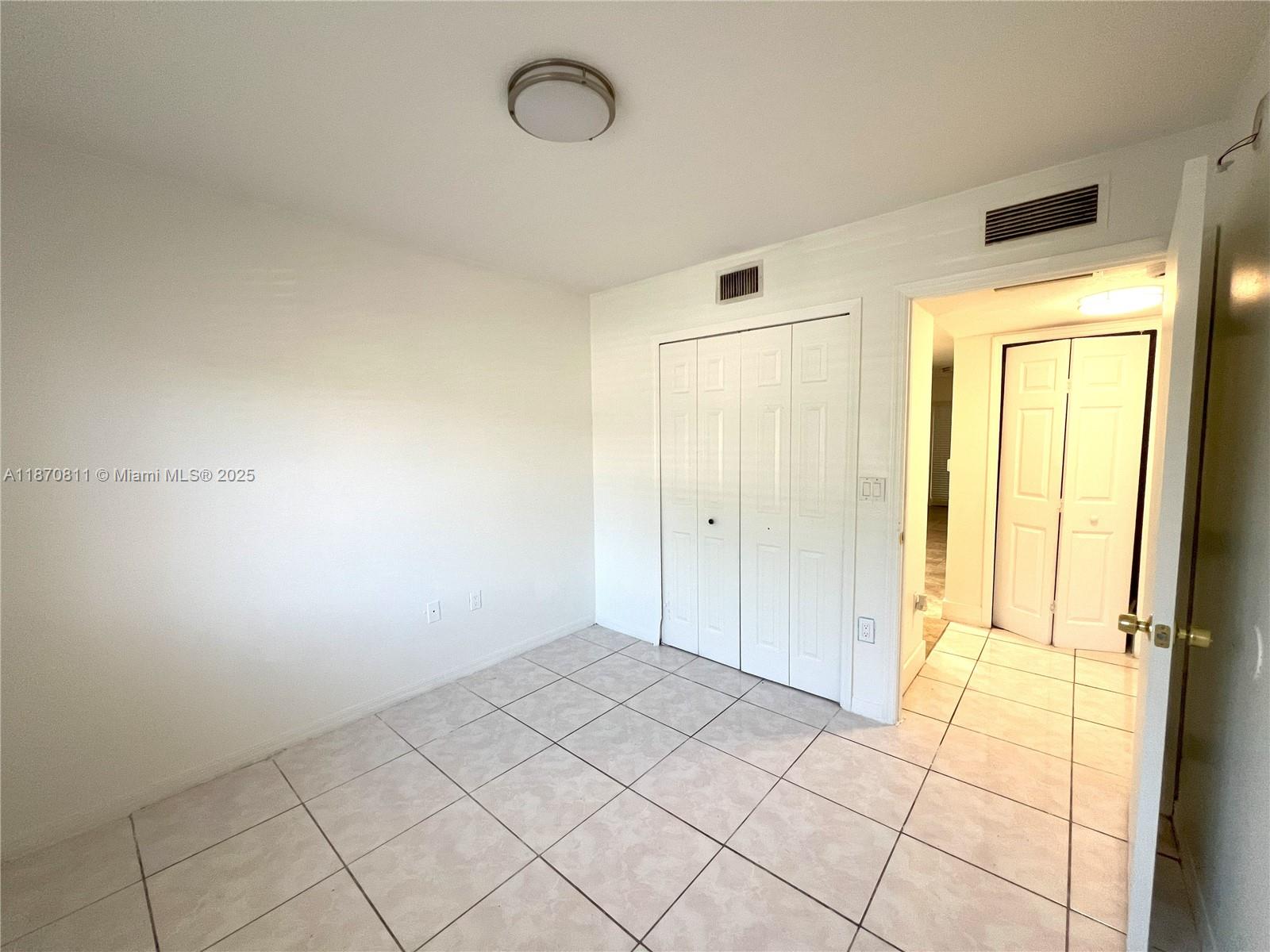 1240 Southeast 28th Court, Unit 101 Homestead, FL 33035 - Photo 17 of 20 a view of an empty room and window