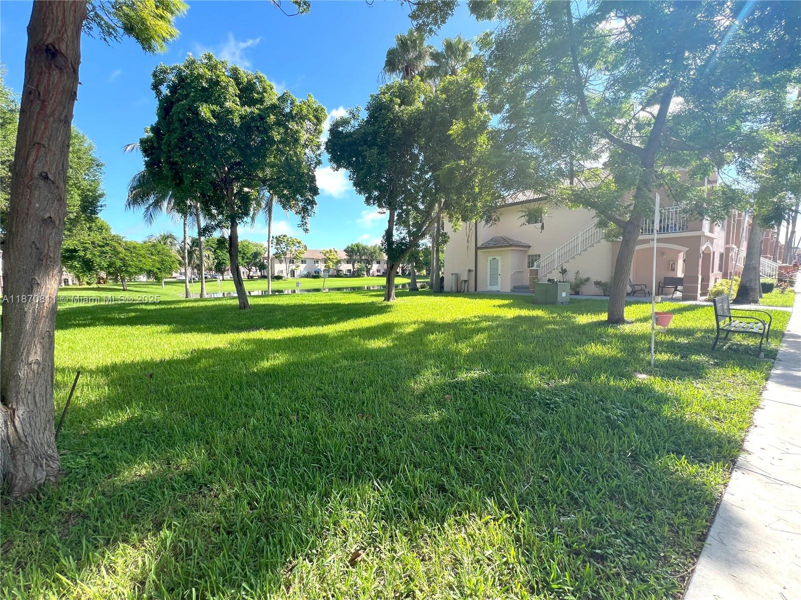 1240 Southeast 28th Court, Unit 101 Homestead, FL 33035 - Photo 20 of 20 a big yard with palm trees
