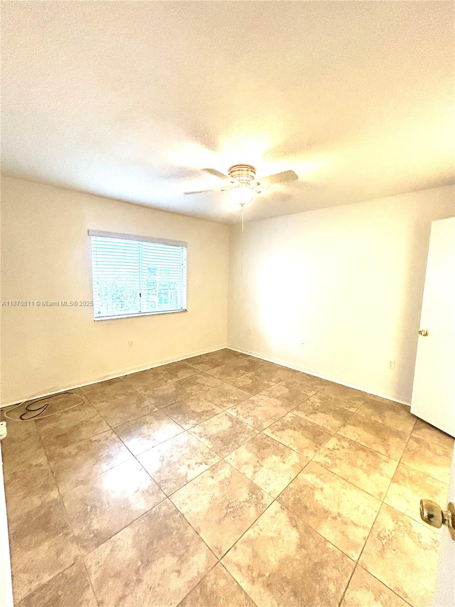 1240 Southeast 28th Court, Unit 101 Homestead, FL 33035 - Photo 8 of 20 a view of an empty room and kitchen