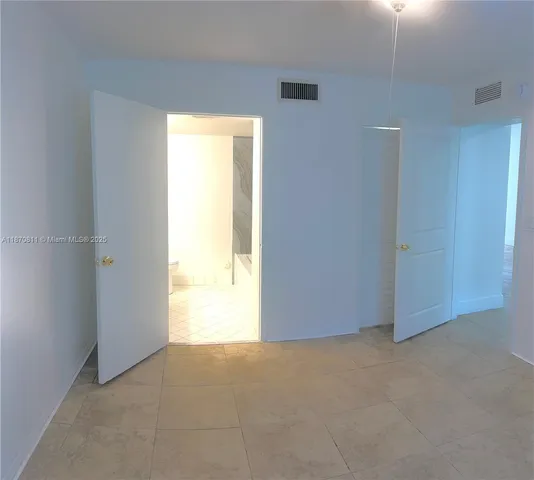 a view of an empty room and a window