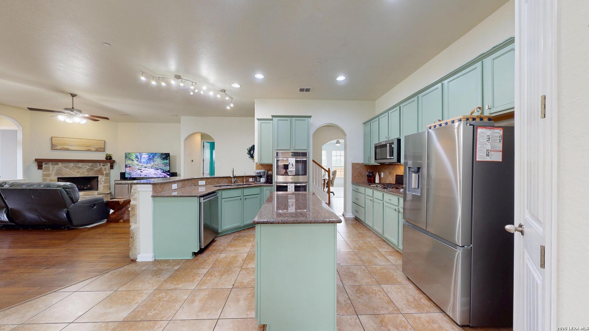 10111 Shallow Bank Converse, TX 78109 - Photo 20 of 65 a kitchen with a refrigerator and a sink