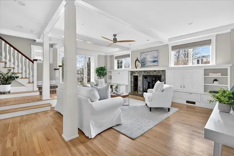 a living room with furniture fireplace and wooden floor
