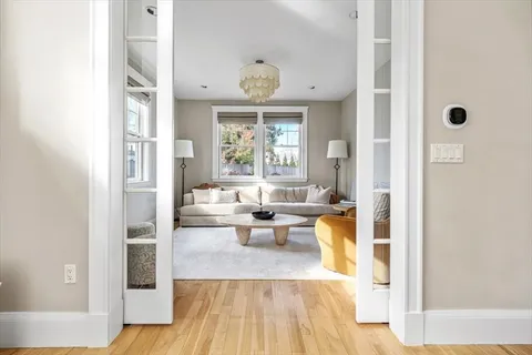 a very nice looking room with a large window and chandelier