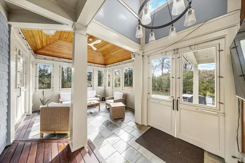 a living room with furniture and large windows