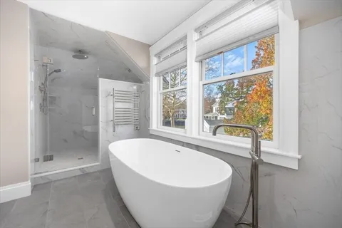 a bathroom with a sink double vanity mirror and a bathtub
