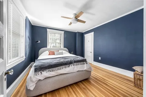 a bedroom with bed couch and window