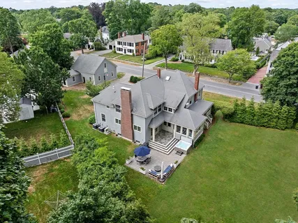 a view of a house with backyard sitting area and garden