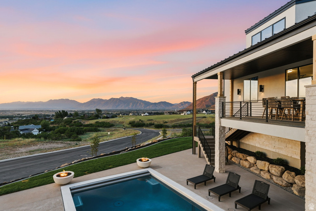 923 North Emery Lane Elk Ridge, UT 84651 - Photo 87 of 101 Contemporary exterior featuring a private swimming pool, two fire bowls, and an upper-level balcony with a railing system