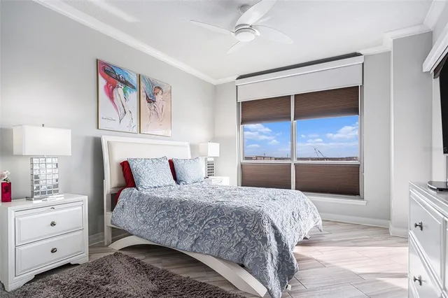 a bedroom with a large bed and a window