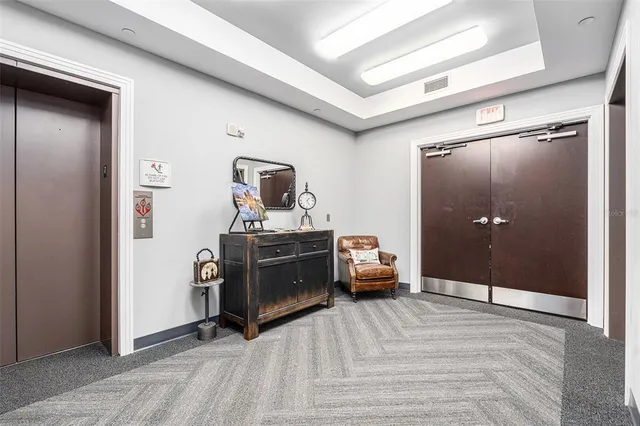a view of a livingroom with furniture and mirror