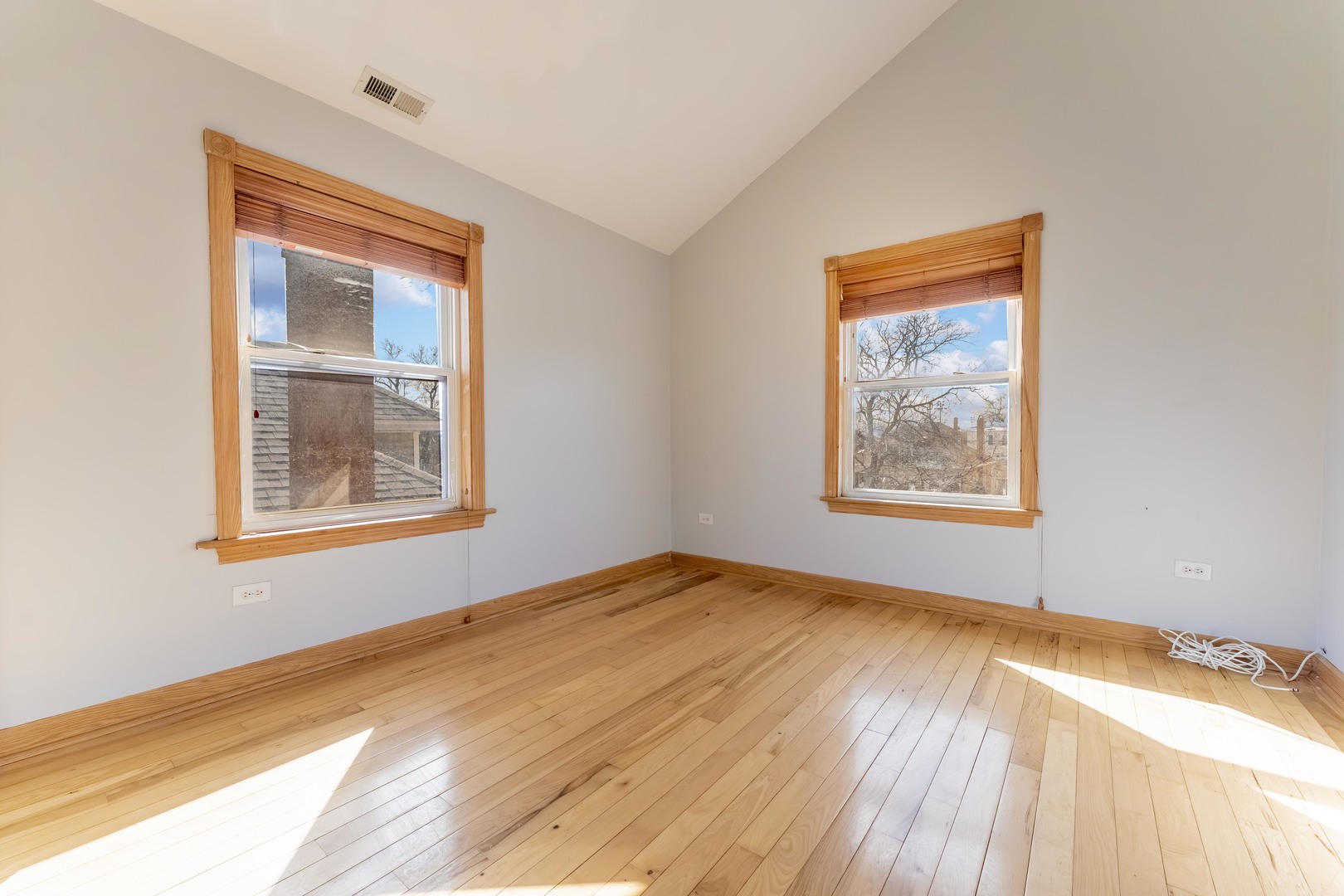 5454 West Eddy Street Chicago, IL 60641 - Photo 11 of 22 a view of an empty room with window and wooden floor
