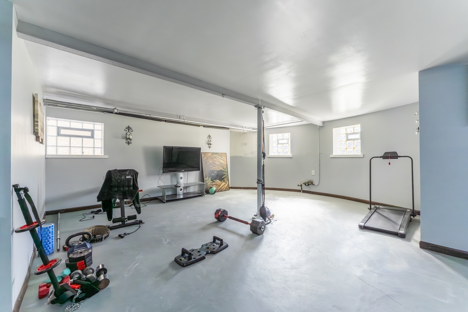 5454 West Eddy Street Chicago, IL 60641 - Photo 17 of 22 a room with gym equipment and a flat screen tv