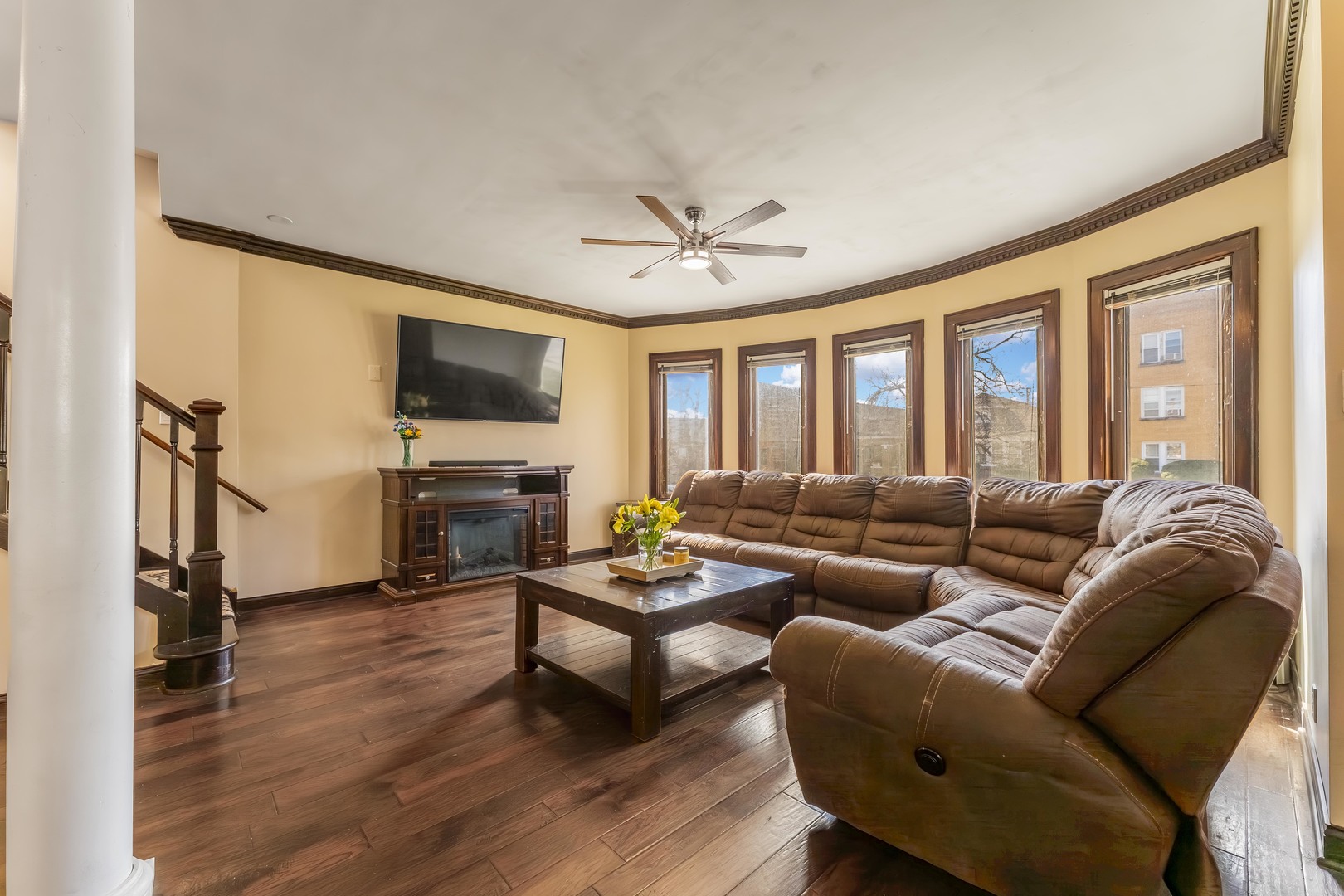 5454 West Eddy Street Chicago, IL 60641 - Photo 2 of 22 a living room with furniture ceiling fan and a flat screen tv