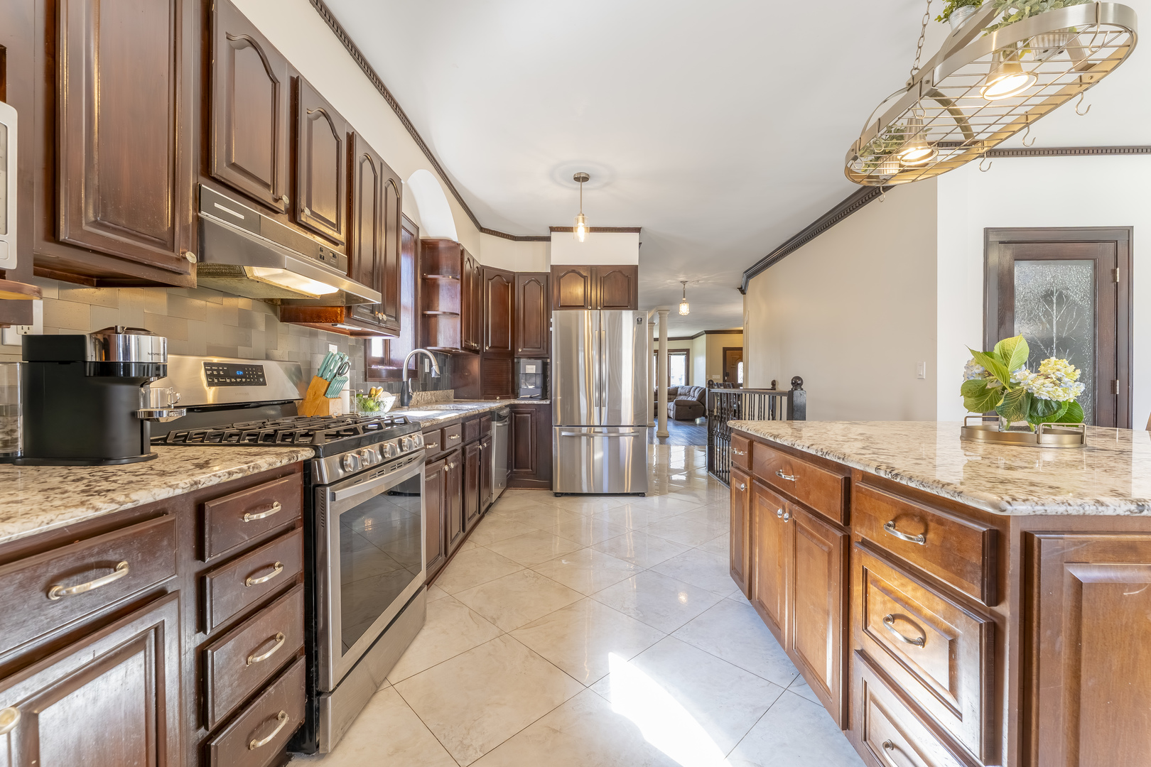 5454 West Eddy Street Chicago, IL 60641 - Photo 6 of 22 a large kitchen with stainless steel appliances granite countertop a lot of counter space and a sink