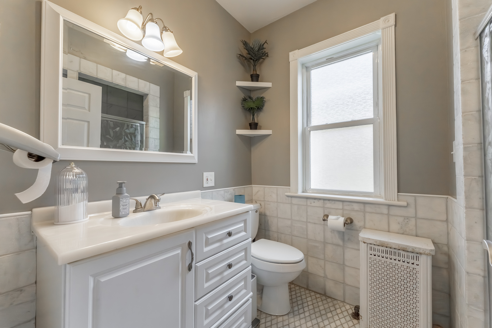 5454 West Eddy Street Chicago, IL 60641 - Photo 8 of 22 a bathroom with a toilet sink and mirror