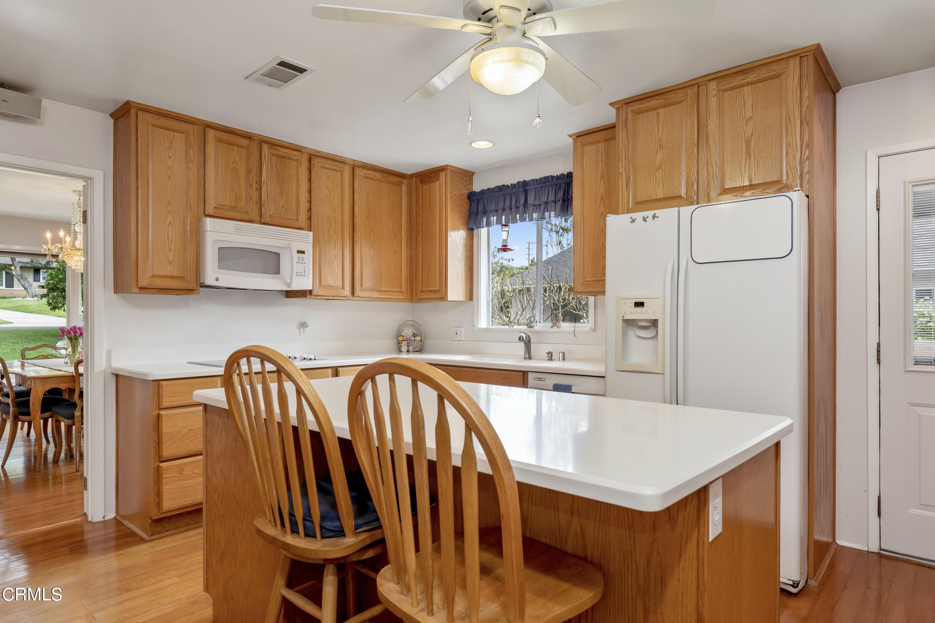 3850 Shadow Grove Road Pasadena, CA 91107 - Photo 20 of 53 a kitchen with a dining table chairs sink and cabinets