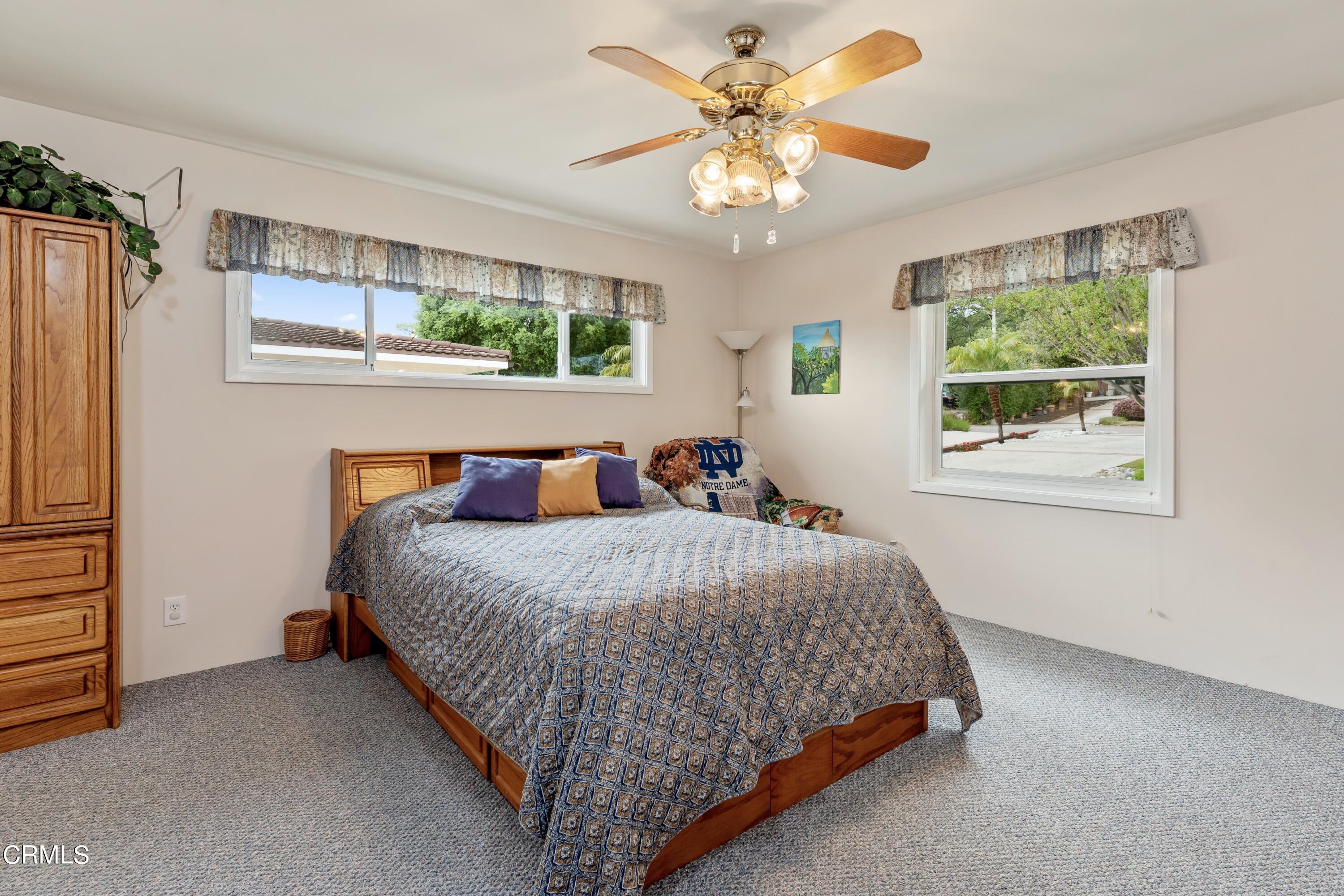 3850 Shadow Grove Road Pasadena, CA 91107 - Photo 27 of 53 a bedroom with a bed chandelier and a window