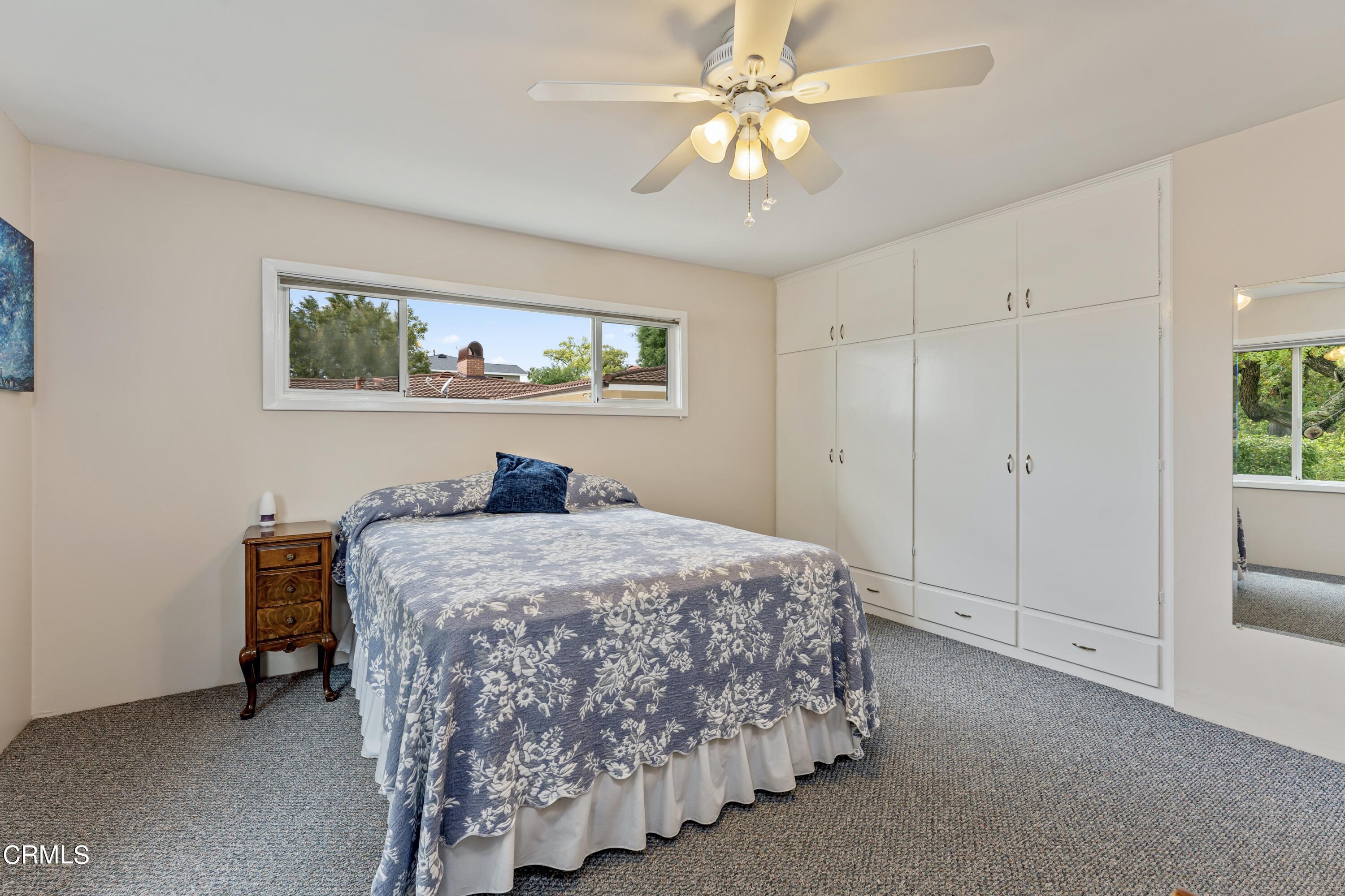 3850 Shadow Grove Road Pasadena, CA 91107 - Photo 33 of 53 a bedroom with a bed and a chandelier