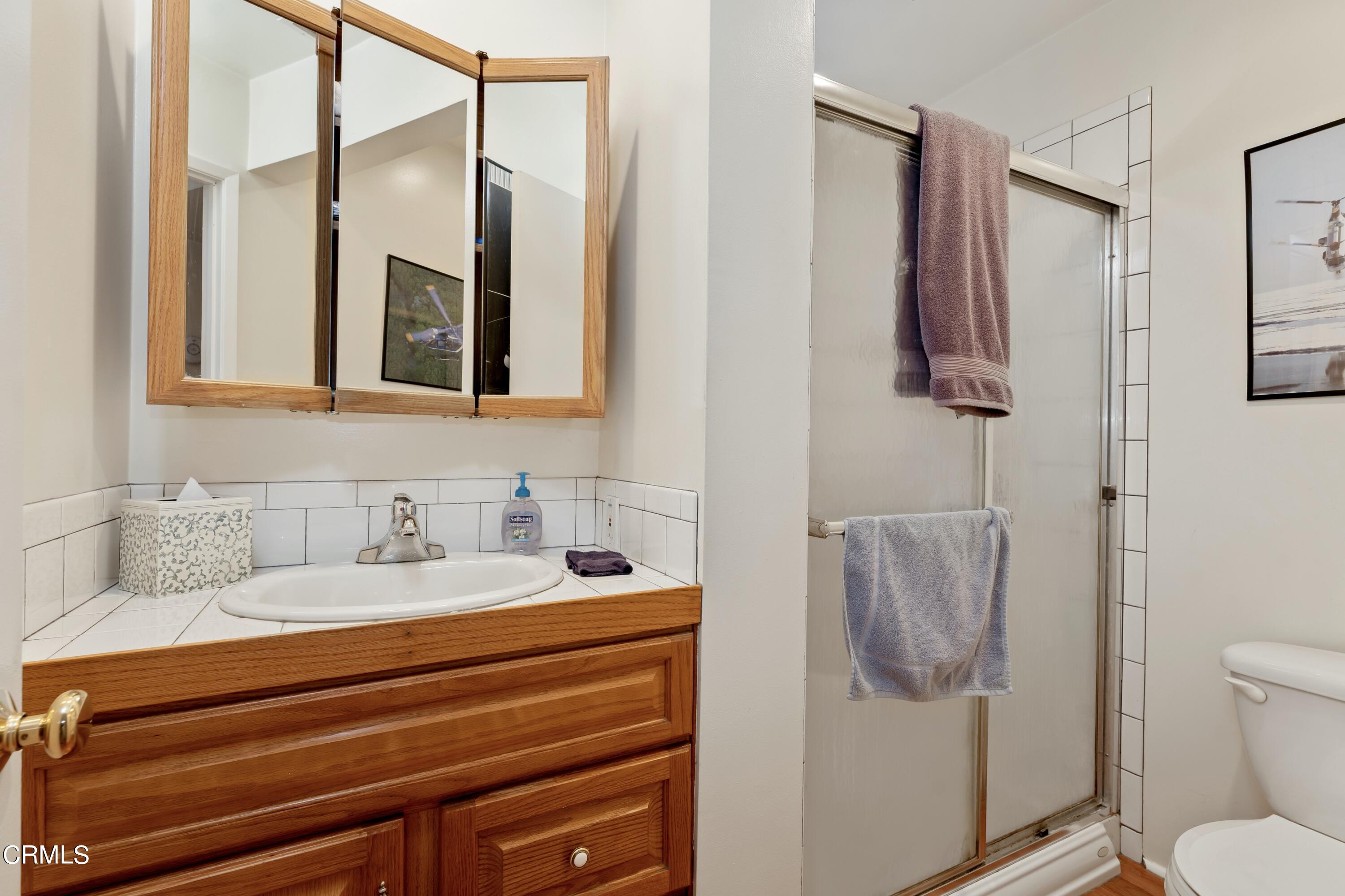 3850 Shadow Grove Road Pasadena, CA 91107 - Photo 35 of 53 a bathroom with a sink toilet and mirror