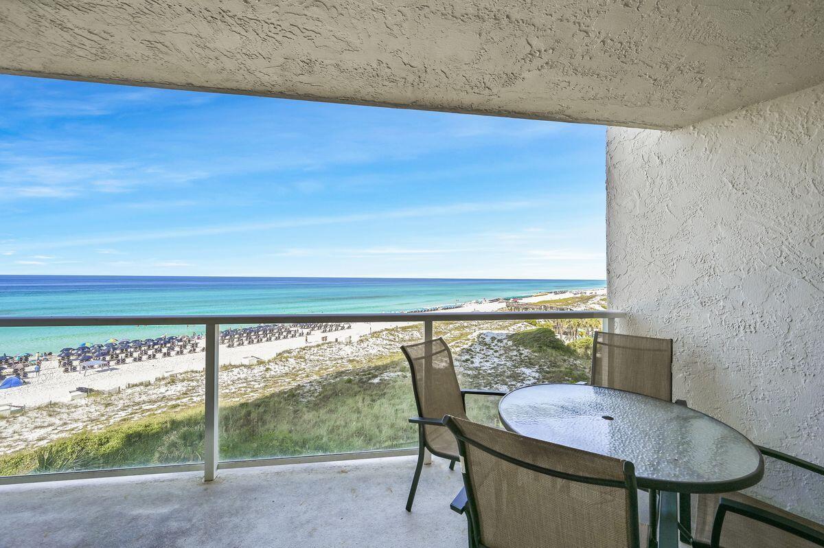 4252 Beachside 2, Unit 252 Miramar Beach, FL 32550 - Photo 1 of 27 a balcony with table and chairs