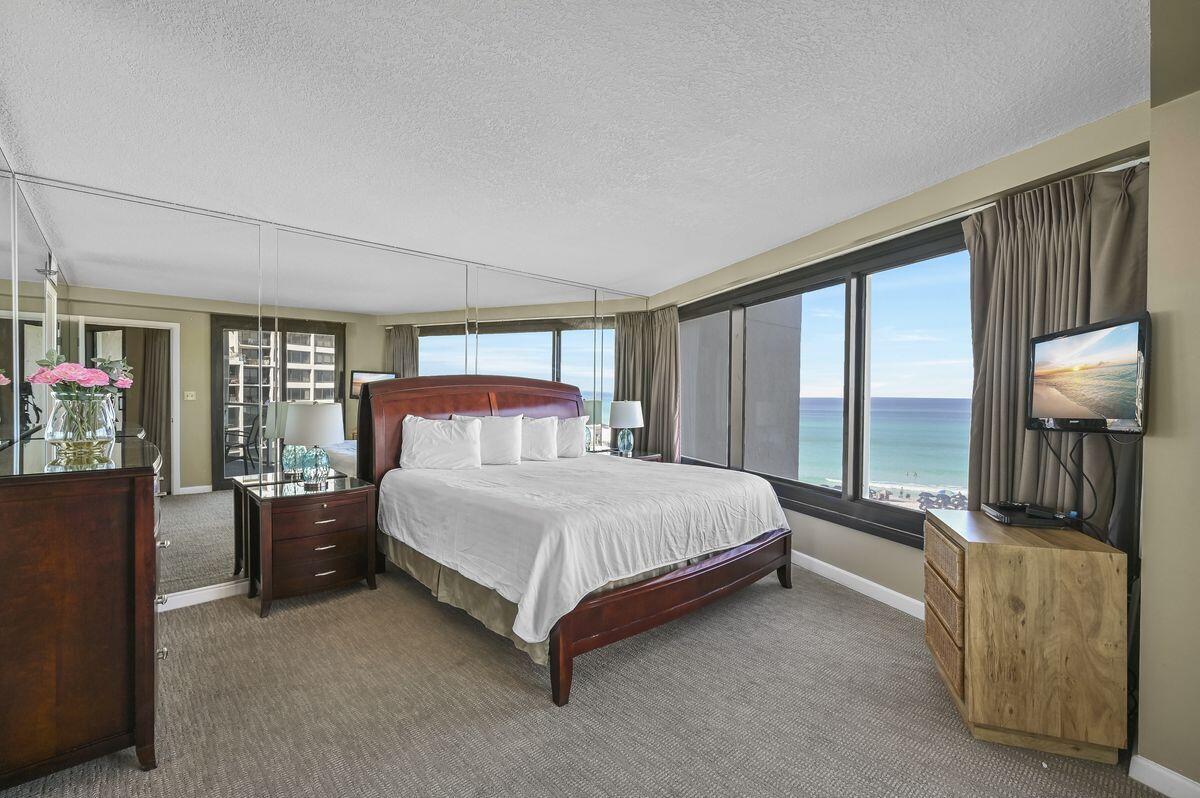 4252 Beachside 2, Unit 252 Miramar Beach, FL 32550 - Photo 13 of 27 a bedroom with a bed and wooden floor