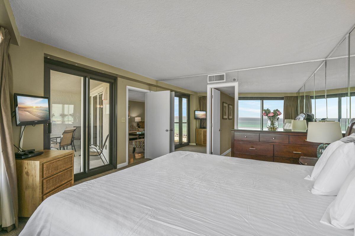 4252 Beachside 2, Unit 252 Miramar Beach, FL 32550 - Photo 15 of 27 a bedroom with a large bed and a view of living room