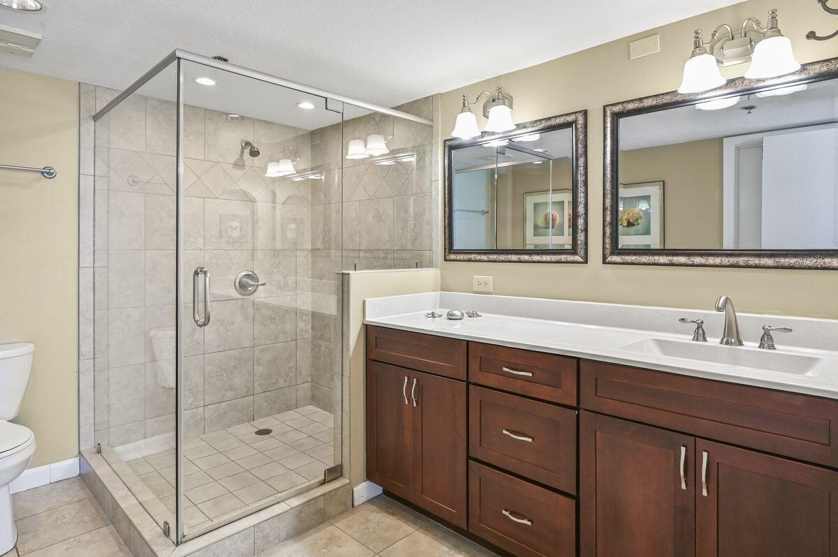 4252 Beachside 2, Unit 252 Miramar Beach, FL 32550 - Photo 16 of 27 a bathroom with a shower sink double vanity and a mirror
