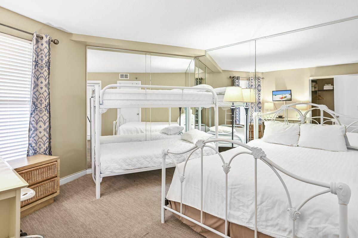 4252 Beachside 2, Unit 252 Miramar Beach, FL 32550 - Photo 17 of 27 a bedroom with a bed and large cabinets